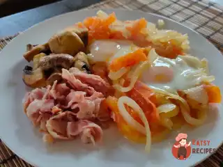 Яєчня з беконом, цибулею, помідором та грибами