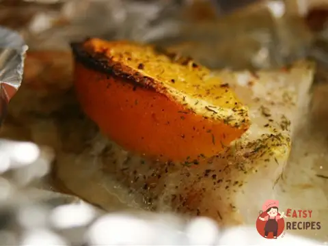 Морський окунь із апельсинами у фользі