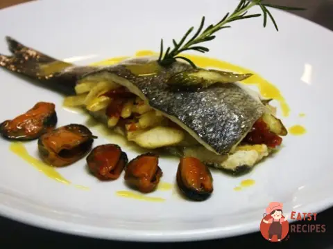 Морський вовк, фарширований овочами, з мідіями та шафрановою олією