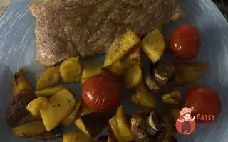 Стейки Із Запеченими Картопляними Часточками, Коктейльними Томатами Та Печерицями