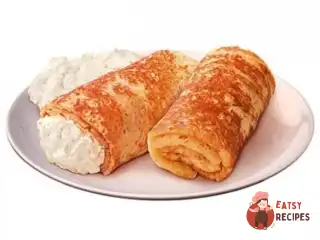 Запечені млинці з сиром та апельсиновим соусом.