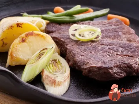 Мариновані яловичі стейки зі смаженою зеленою цибулею
