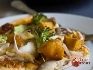 Піца з гарбузом, карамелізованою цибулею, горгонзолою і хрустким смаженим листям шавлії.