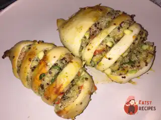 Кальмар фарширований кіноа та овочами.