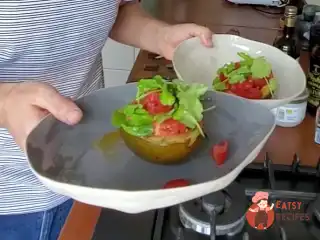 Запечене авокадо з яйцем пашот і помідорами.